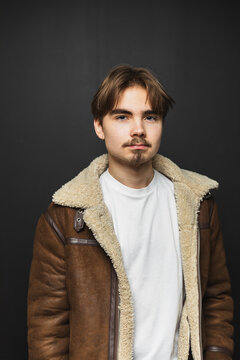 Portrait of a stylish young man on a black background