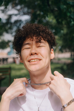 Smiling Young Man with Curly Hair Outdoors