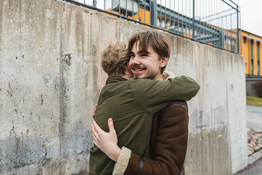 Authentic Emotional Hug Between Two Male Friends Outdoors