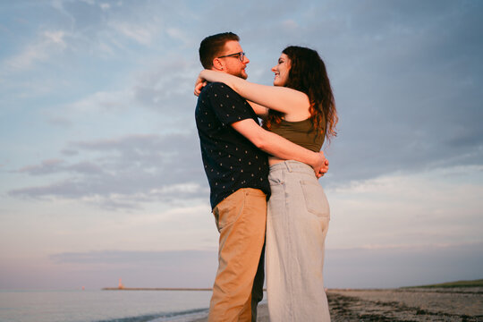 couple embracing and having fun at the beach. 