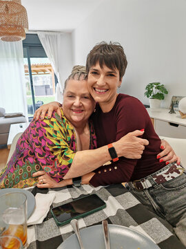 Women hugging and smiling demonstrating togetherness and affection
