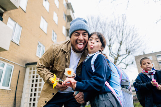 Father and daughter making funny faces together