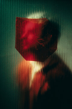Person behind textured glass