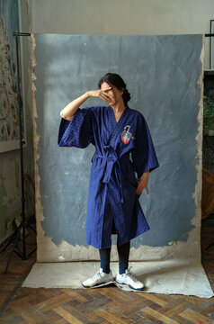 portrait of a woman in a blue kimono
