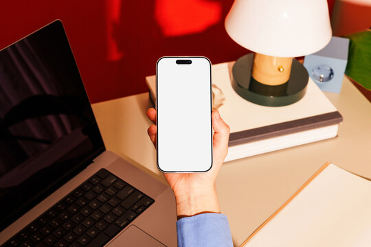 Smartphone mockup with white screen at office desk