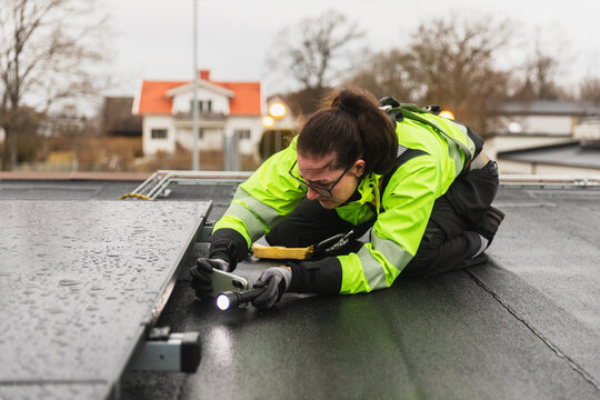 Close-up portrait of a woman technician performing manual maintenance
