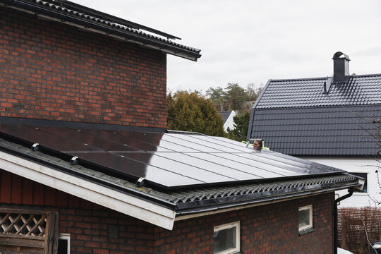 Integrated solar photovoltaic panels on a brick house roof