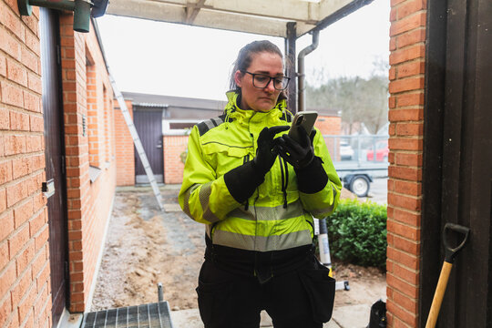 Female Electrician Using Digital App for Residential Inspection