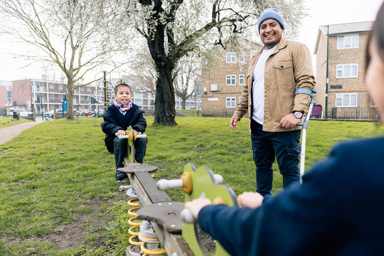 Parent picking up children from school playground
