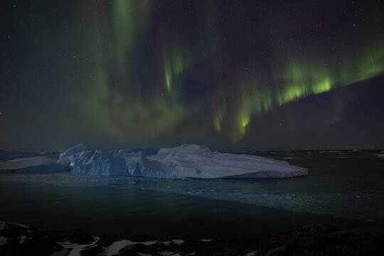 Northern lights over an Iceberg in Greenland