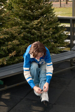 Woman ties her shoelaces on skates