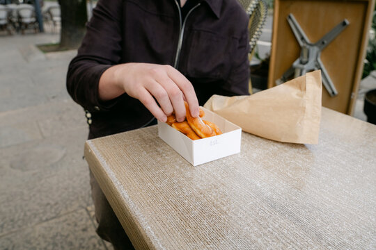 close up of young man eating  bugne in Lyon France