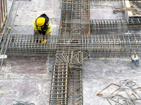 Worker Tying Steel Rebar Reinforcement on Formwork