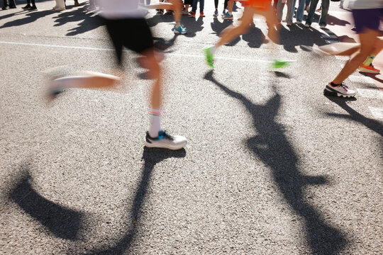 Runners Participate in City Marathon Event on Busy Street