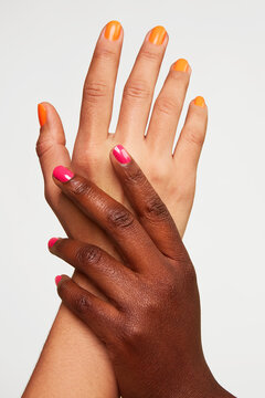 Diverse hands with colorful manicured nails showing unity