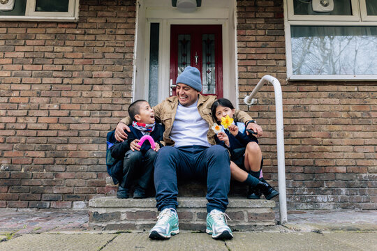 Father enjoying happy reunion with school children