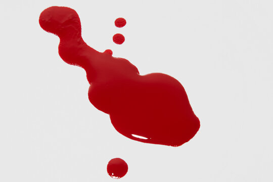Red nail polish spill droplets on surface