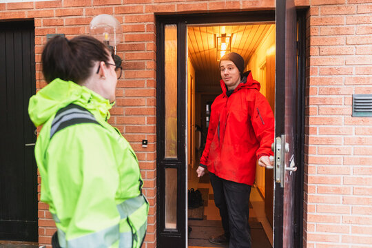 Technician Greeting Homeowner at Entrance for Service Appointment