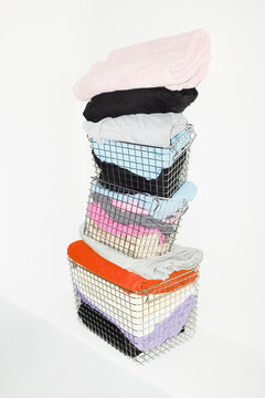 Silver wire baskets full of colourful fabrics and clothes with flash
