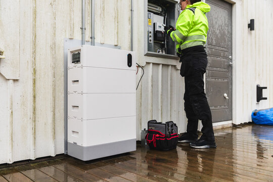 Electrician Checking Residential Home Battery Storage System