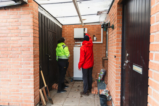 Specialist Showing Energy System Components to Homeowner