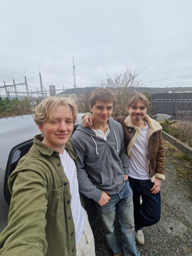 Three young adult male students posing together