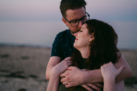tender moment between couple a the beach