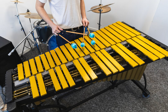 Professional Musician Playing Golden Vibraphone with Mallets