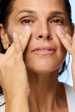 Woman Practicing Skincare Routine in a Bright Room