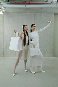 Fashion women shoppers taking selfie with shopping bags mock up