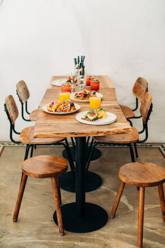 Brunch table with waffles avocado toast and fresh orange juice