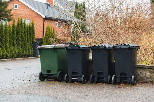 Row of Domestic Waste and Recycling Bins on Residential Street