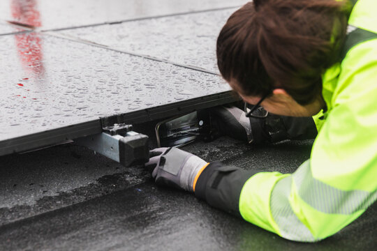 Close-up of Technician Inspecting Solar Panel