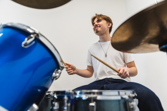 Happy Young Drummer Playing Blue Drum Set
