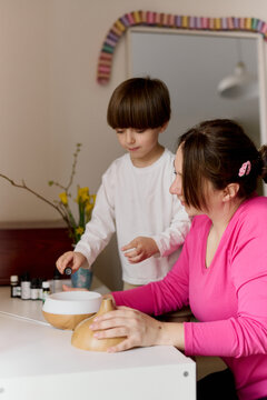 Mother and child using essential oil diffuser at home
