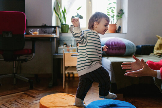 Toddler Learning To Walk Toward Parent At Home