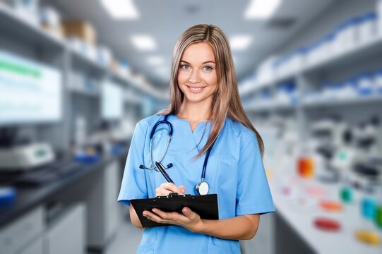 Smiling young doctor on office background