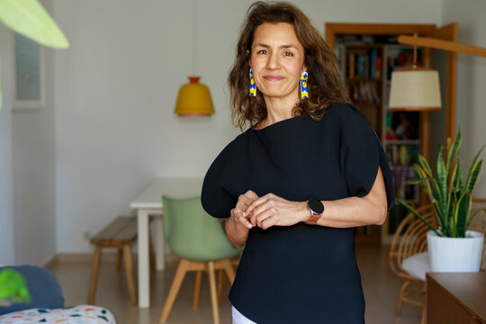 Woman Stands in a Modern Room With Colorful Accessories