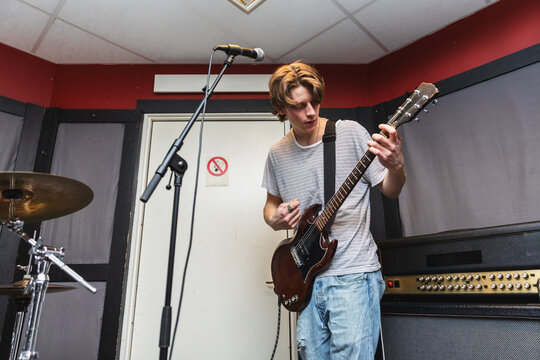 Passionate Male Vocalist Singing and Playing Electric Guitar