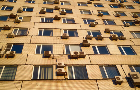 Many Air Conditioning Units on a City Office Building Facade