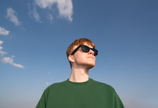 Redhead Man Wearing Smart Sunglasses in Blue Sky 