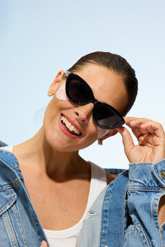Model Poses With Sunglasses Outside During Daylight