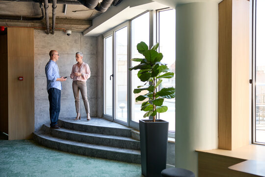 Coworkers chat in the corporate setting