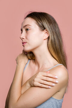 Woman Holding Shoulder In Profile