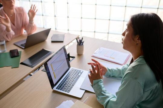 Colleagues talk to each other at the office