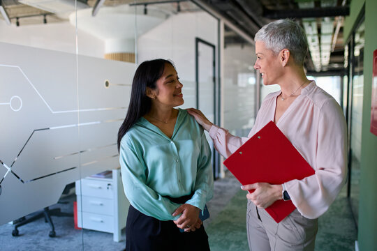 Women talk business in the hallway