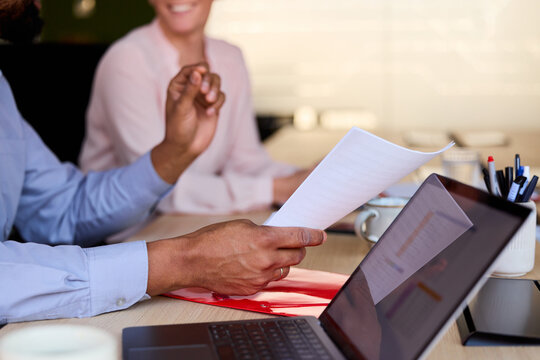 Businessman holds a bunch of papers on a meeting