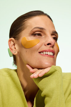 Woman Enjoys Skin Care Routine With Eye Patches in Bright Setting