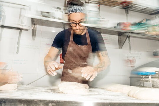 Baker preparing artisan dough motion blur