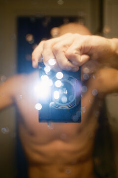 Person Takes Selfie Picture in Home Bathroom With Direct Flash